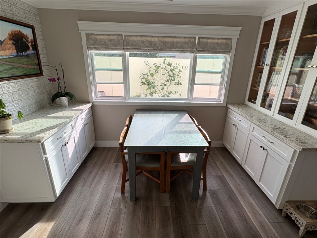 15471 Victoria Huntington Beach, CA 92647 - Photo 10 of 37 a kitchen with a wooden floor and a window