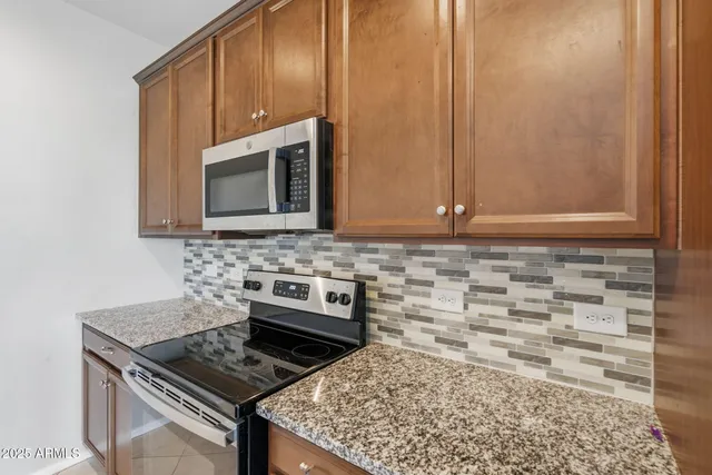 a view of a kitchen with refrigerator and cabinets