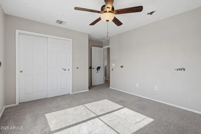a view of room with window and ceiling fan