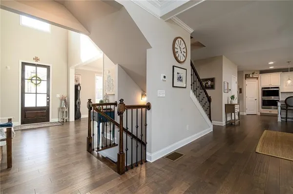 wooden floor with a large window and a clock