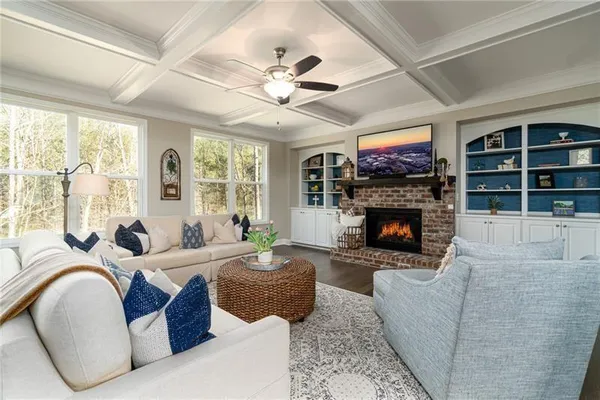 a living room with furniture a fireplace and a large window