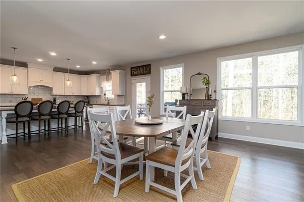 a view of a dining room with furniture and wooden floor