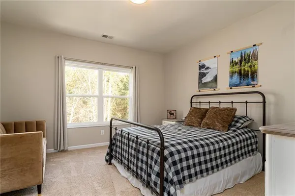 a bedroom with a bed and window