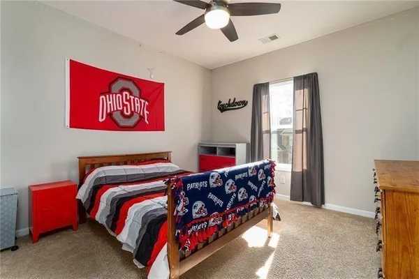 a bed sitting in a bedroom next to a window