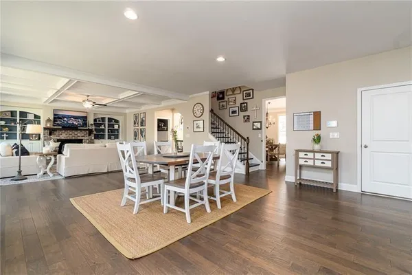 a living room with furniture wooden floor and a table