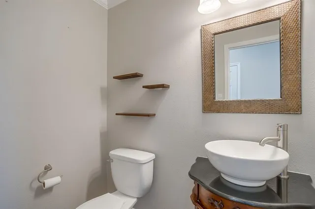 a bathroom with a toilet a sink and mirror
