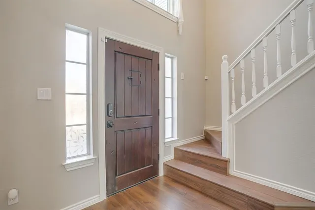 a view of an entryway with wooden floor and door