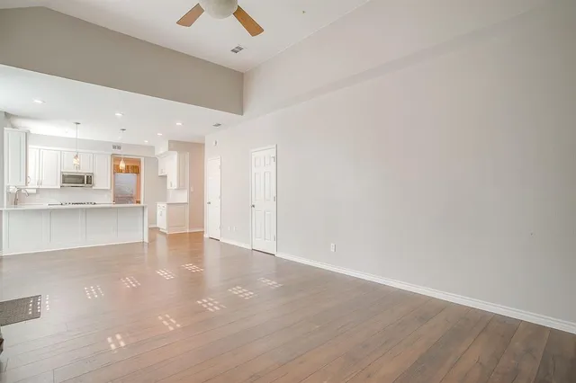 a view of kitchen with refrigerator and window