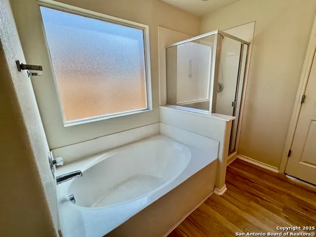 a bathroom with a tub and a shower