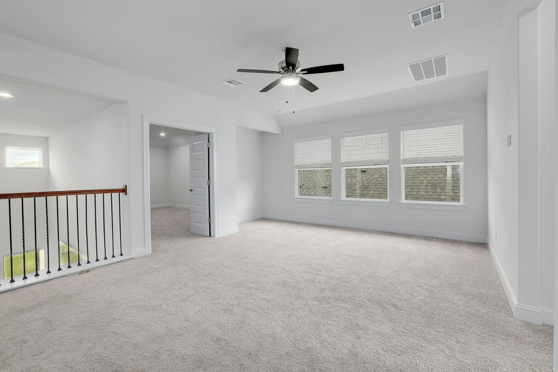 2040 Base Burner Path Leander, TX 78641 - Photo 15 of 31 Empty room with ceiling fan, light colored carpet, and plenty of natural light