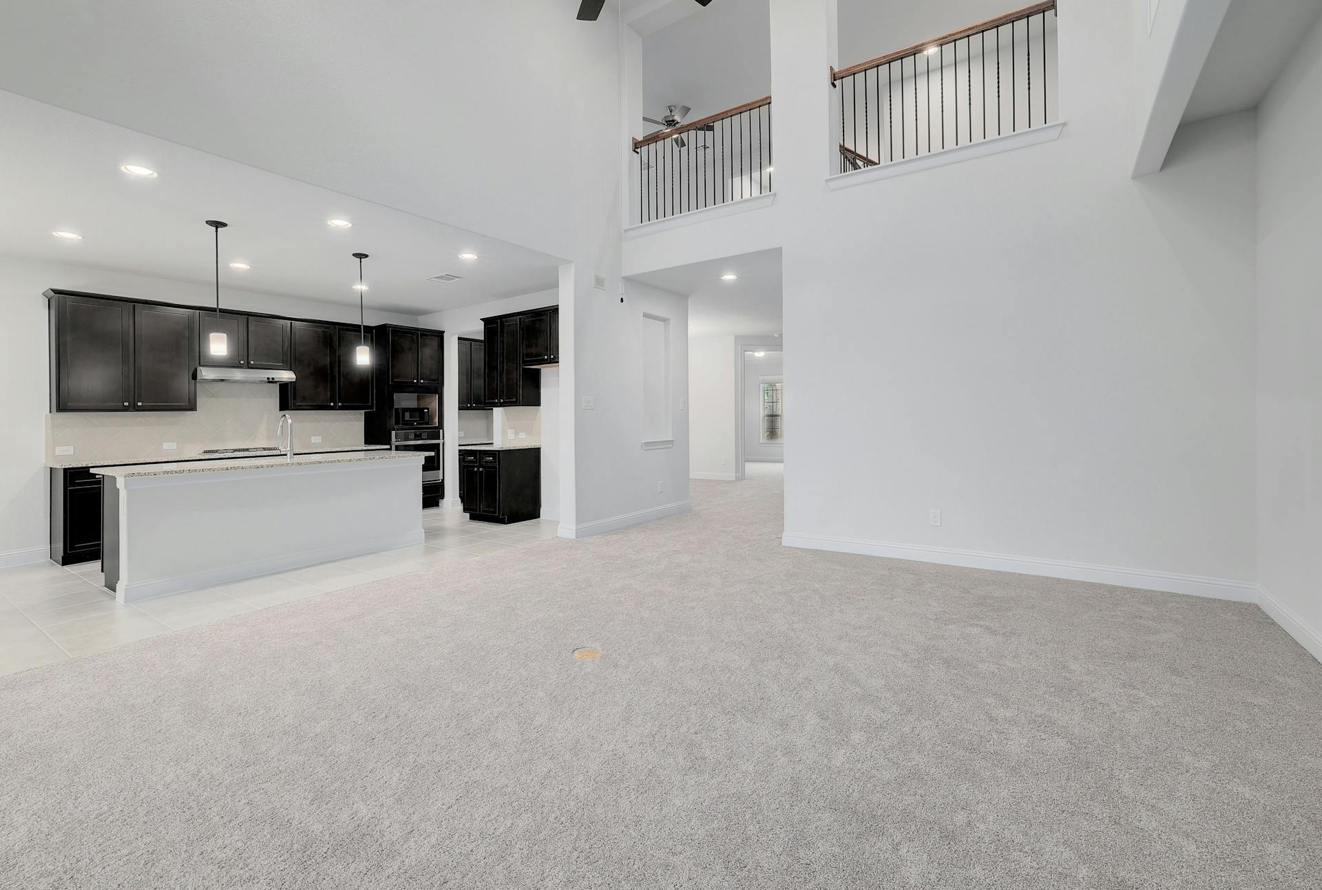 2040 Base Burner Path Leander, TX 78641 - Photo 3 of 31 Unfurnished living room with light colored carpet, a ceiling fan, recessed lighting, and a high ceiling