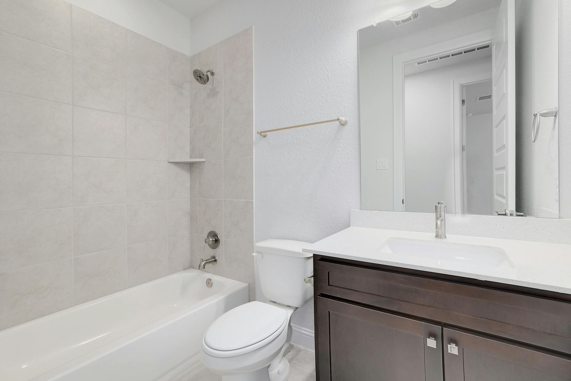 2040 Base Burner Path Leander, TX 78641 - Photo 30 of 31 Full bath featuring tub / shower combination, vanity, and a textured wall