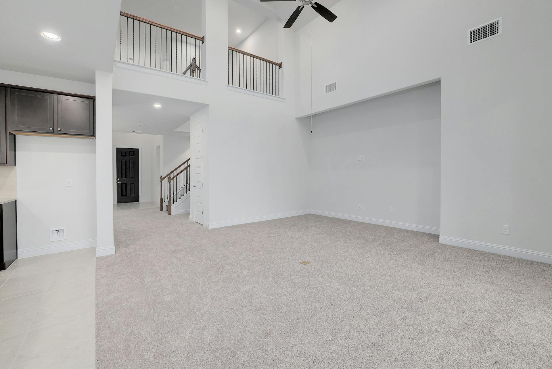 2040 Base Burner Path Leander, TX 78641 - Photo 5 of 31 Unfurnished living room with light carpet, a high ceiling, a ceiling fan, and recessed lighting