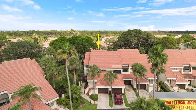 an aerial view of house with yard and mountain view in back
