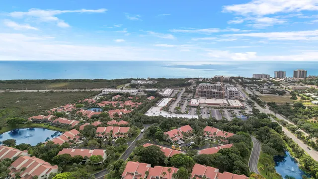 an aerial view of ocean and residential houses