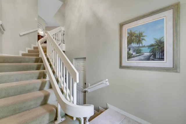 a view of staircase with wooden floor and a rug