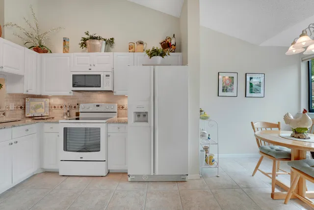 a kitchen with stainless steel appliances a stove a microwave and a refrigerator