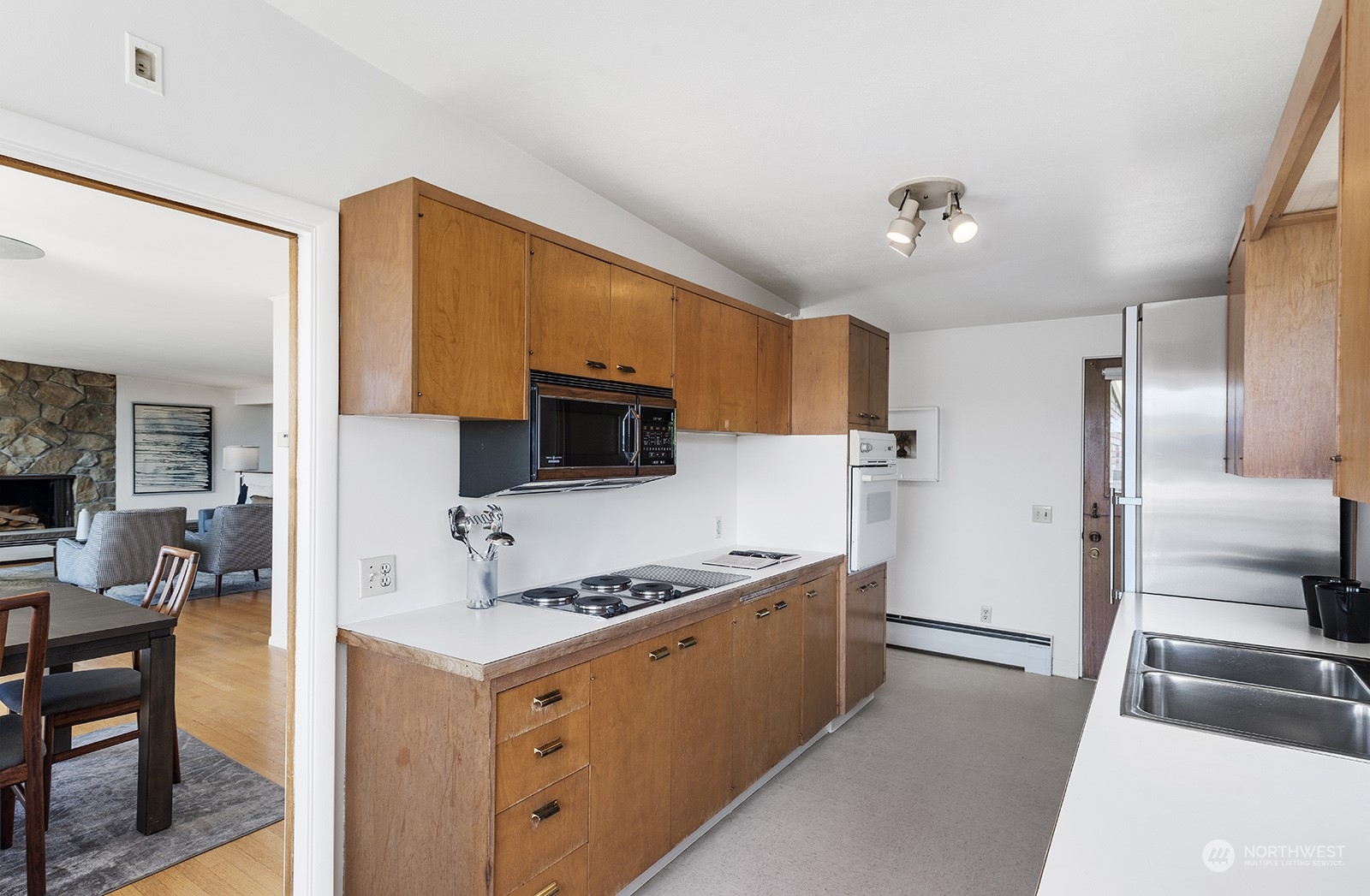 3513 West Howe Street Seattle, WA 98199 - Photo 11 of 39 a kitchen with stainless steel appliances granite countertop a refrigerator and a stove top oven