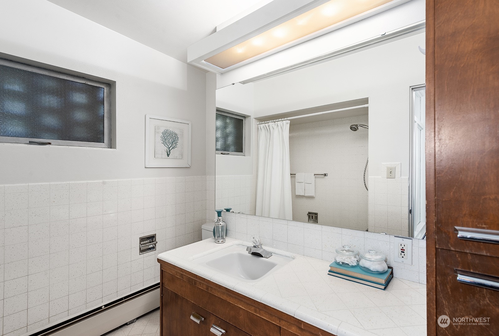 3513 West Howe Street Seattle, WA 98199 - Photo 16 of 39 a bathroom with a sink a vanity and a mirror