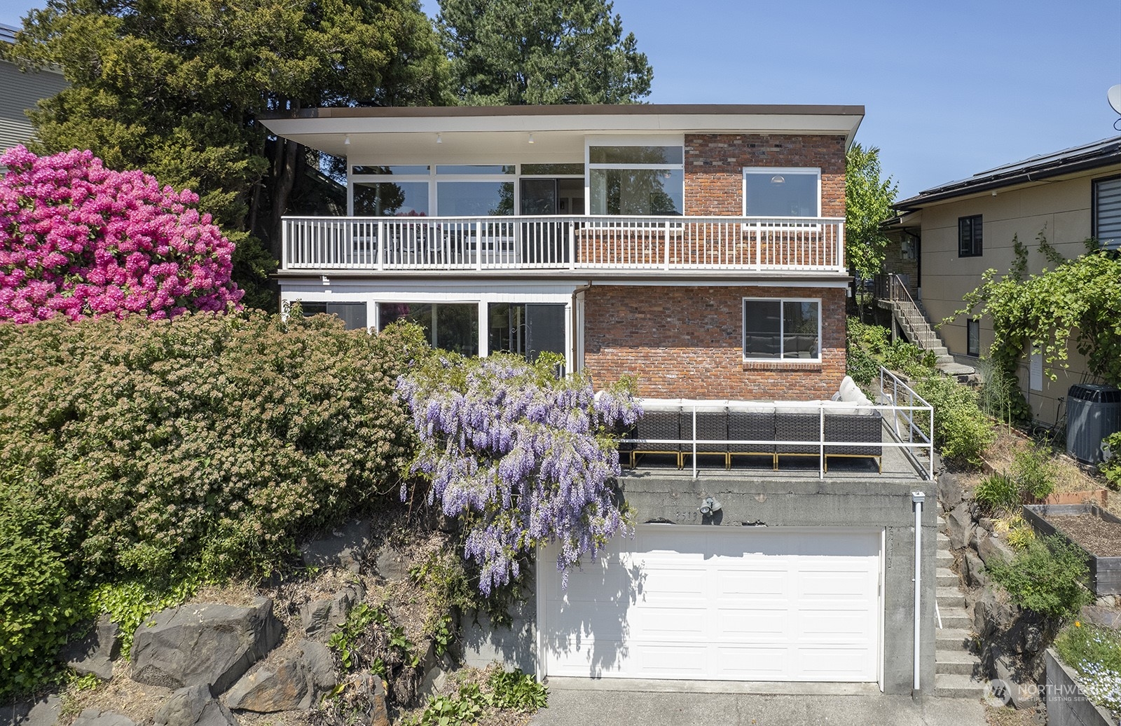 3513 West Howe Street Seattle, WA 98199 - Photo 3 of 39 a front view of a house with a yard