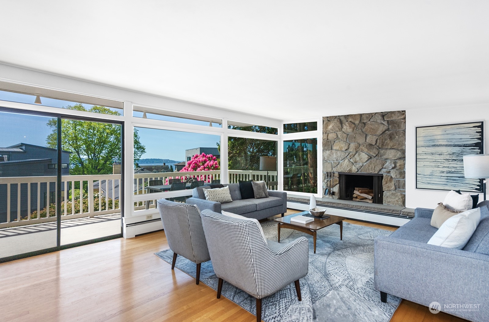 3513 West Howe Street Seattle, WA 98199 - Photo 5 of 39 a living room with furniture potted plant floor to ceiling window and a fireplace