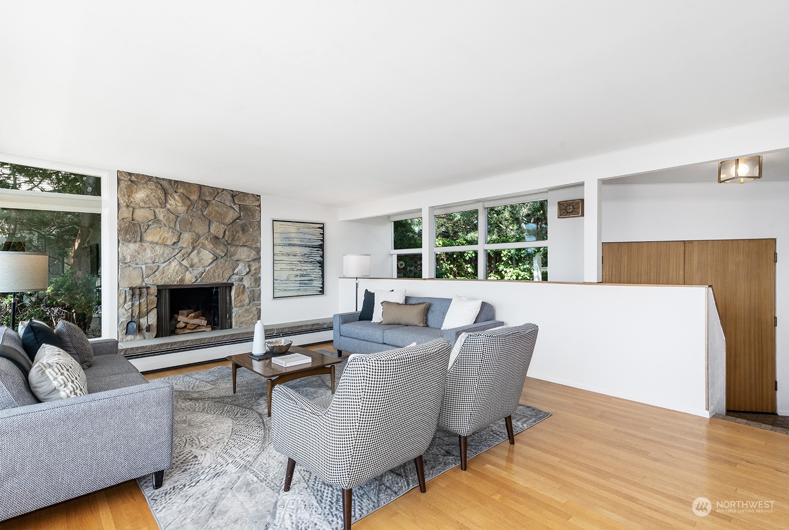 3513 West Howe Street Seattle, WA 98199 - Photo 7 of 39 a living room with furniture and a fireplace
