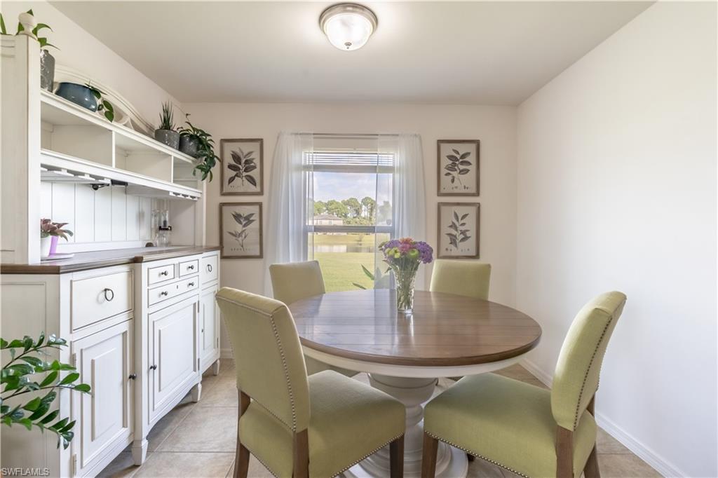 727 Morningview Court Lehigh Acres, FL 33974 - Photo 13 of 40 a dining room with furniture and window