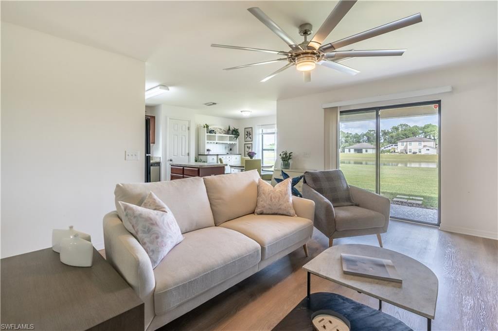 727 Morningview Court Lehigh Acres, FL 33974 - Photo 5 of 40 a living room with furniture and a large window with wooden floor