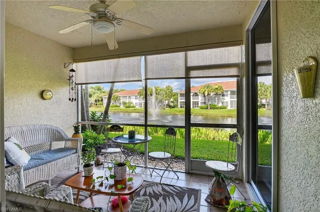 a living room with fireplace furniture and a large window