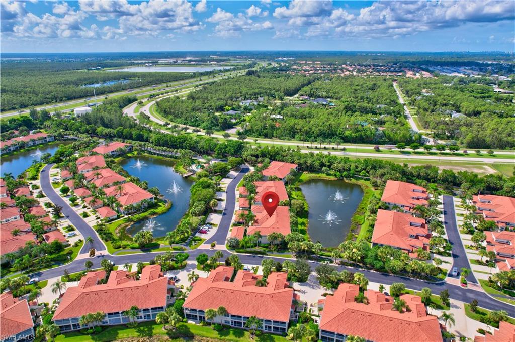 23800 Costa Del Sol Road, Unit 102 Estero, FL 34135 - Photo 41 of 49 an aerial view of swimming pool outdoor seating and yard