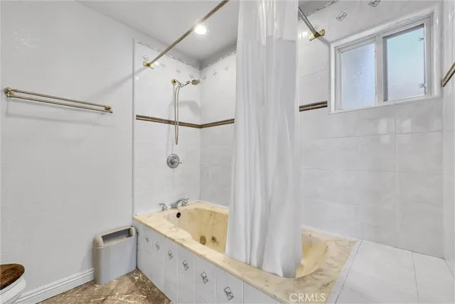 a bathroom with a tub a sink and a shower