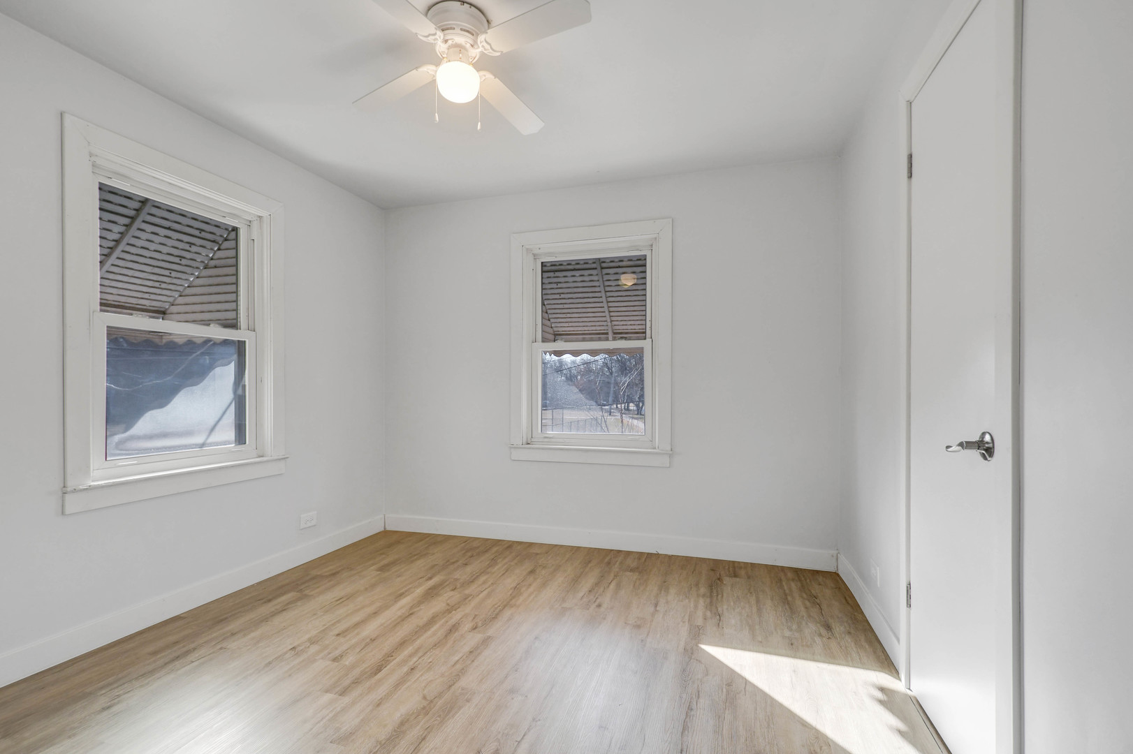 10313 South Church Street Chicago, IL 60643 - Photo 19 of 27 a view of an empty room with wooden floor and a window