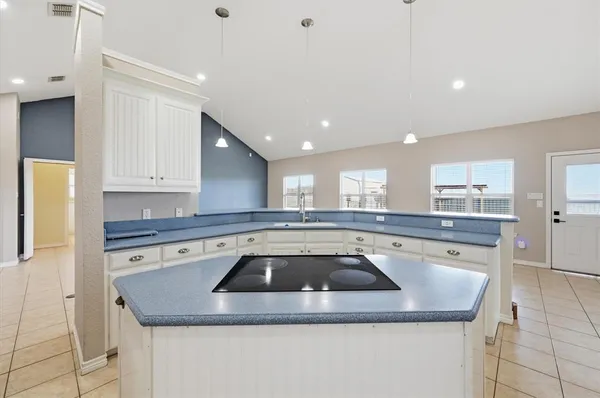 a kitchen with a sink a counter top space and cabinets