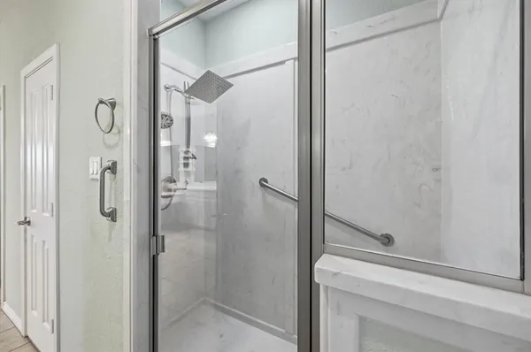 a bathroom with a shower and a sink