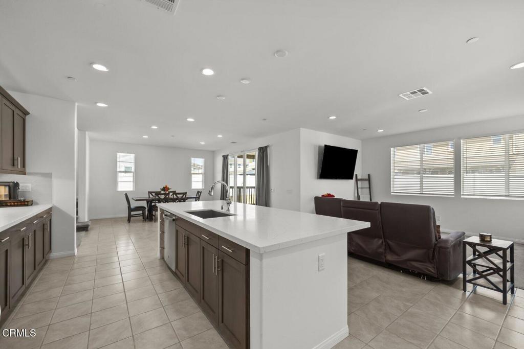 151 Rose Street Fillmore, CA 93015 - Photo 16 of 49 a large kitchen with kitchen island a sink a counter space and stainless steel appliances