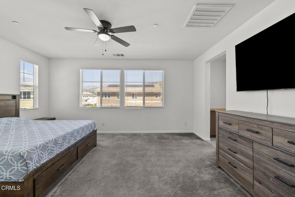 151 Rose Street Fillmore, CA 93015 - Photo 22 of 49 a spacious bedroom with a bed and a flat screen tv