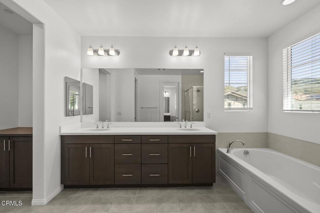 151 Rose Street Fillmore, CA 93015 - Photo 26 of 49 a spacious bathroom with a granite countertop bathtub sink double and mirror