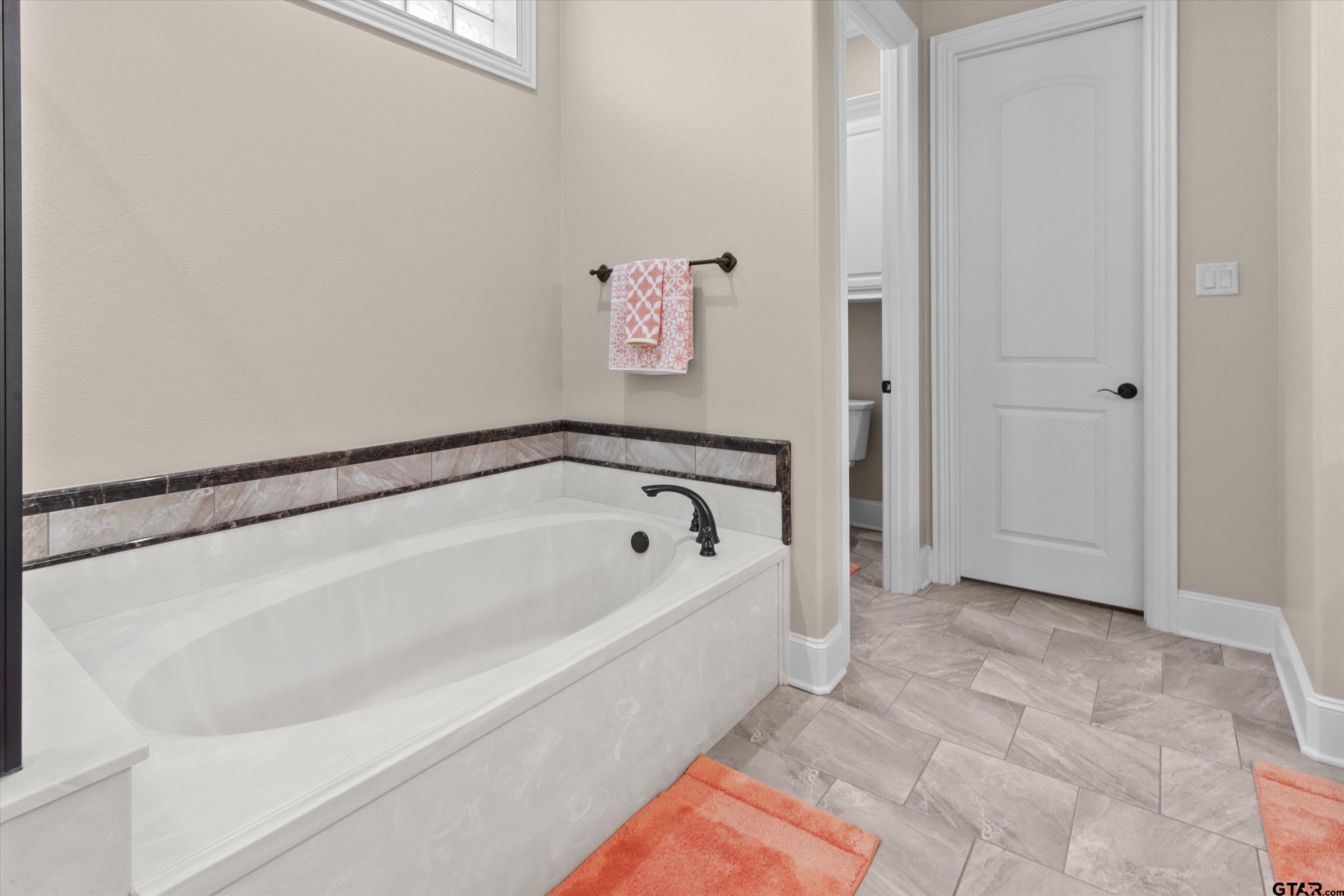 7423 Princedale Tyler, TX 75703 - Photo 20 of 31 a spacious bathroom with a bathtub and shower