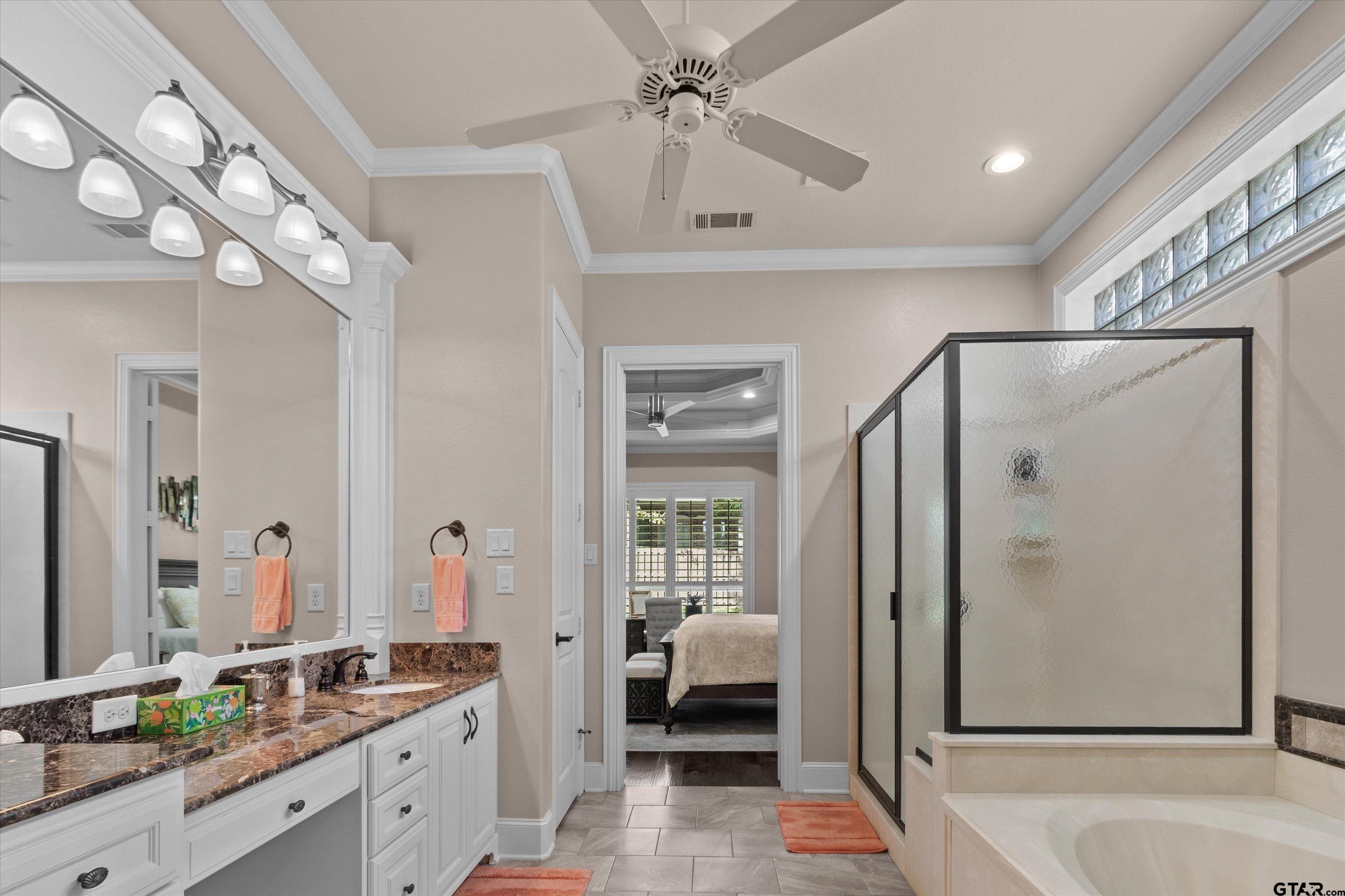 7423 Princedale Tyler, TX 75703 - Photo 22 of 31 a spacious bathroom with a granite countertop sink a mirror a vanity and a shower