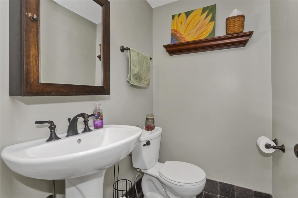 70 Corey Colonial, Unit 70 Agawam, MA 01001 - Photo 12 of 23 a bathroom with a sink mirror and toilet
