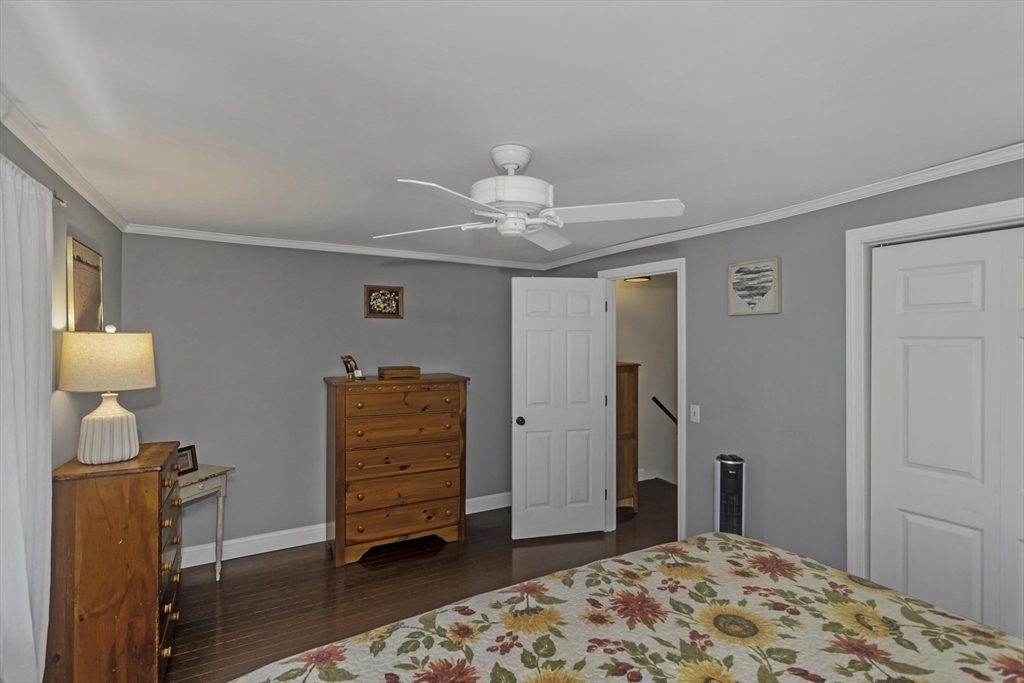 70 Corey Colonial, Unit 70 Agawam, MA 01001 - Photo 14 of 23 a bedroom with a bed and wooden floor