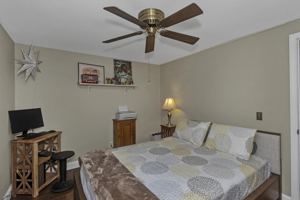70 Corey Colonial, Unit 70 Agawam, MA 01001 - Photo 17 of 23 a bedroom with a bed and a table in it