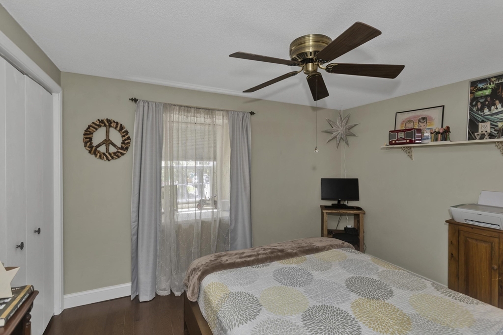 70 Corey Colonial, Unit 70 Agawam, MA 01001 - Photo 18 of 23 a bedroom with a bed and a chandelier