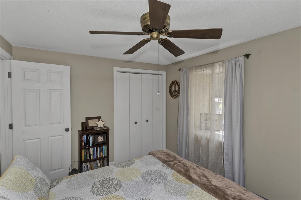 70 Corey Colonial, Unit 70 Agawam, MA 01001 - Photo 19 of 23 a bedroom with a bed and a chandelier
