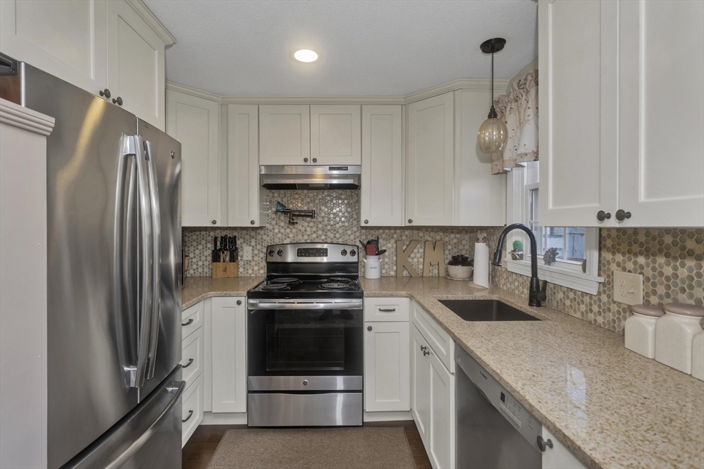 70 Corey Colonial, Unit 70 Agawam, MA 01001 - Photo 6 of 23 a kitchen with stainless steel appliances granite countertop a sink stove and refrigerator