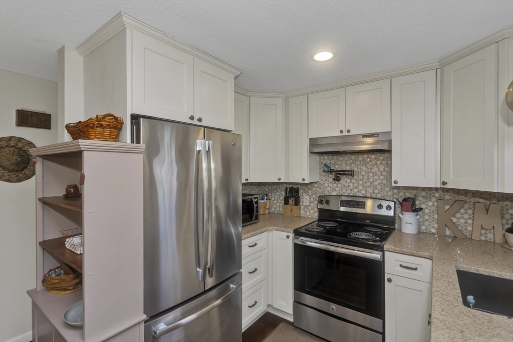70 Corey Colonial, Unit 70 Agawam, MA 01001 - Photo 7 of 23 a kitchen with stainless steel appliances and refrigerator