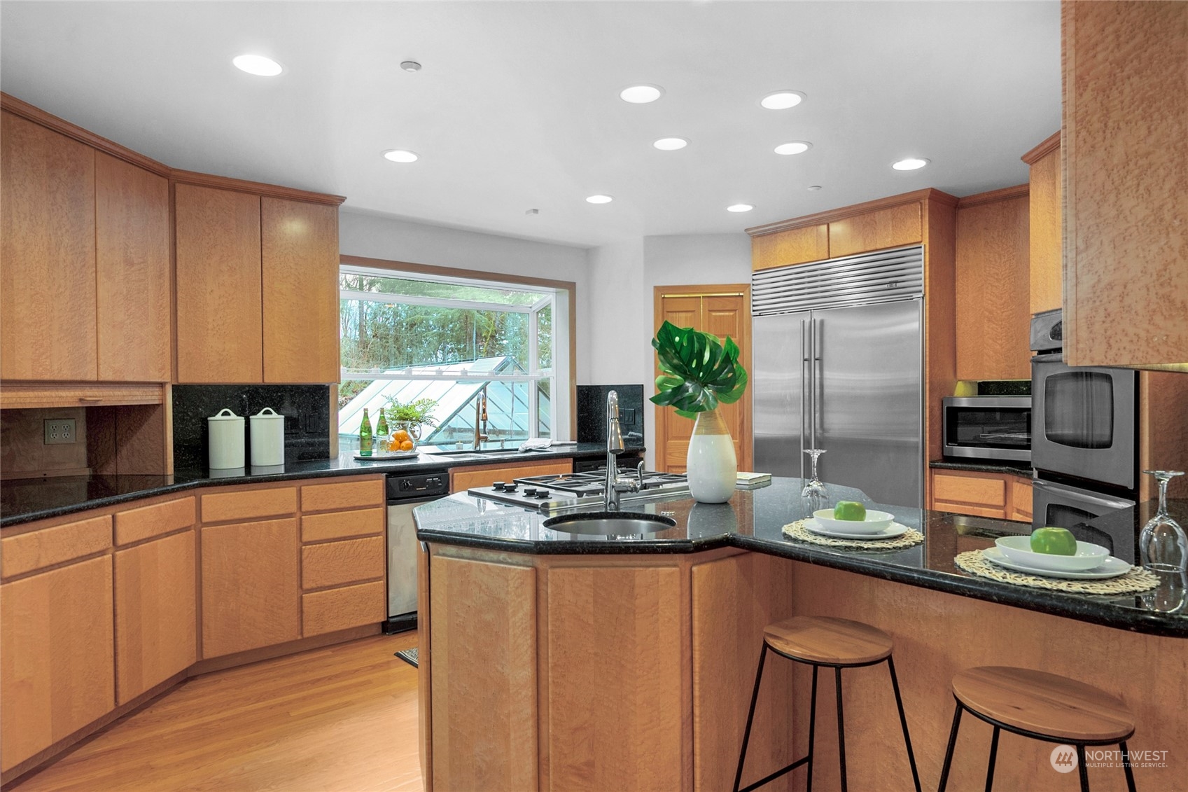 33233 Northeast 70th Street Carnation, WA 98014 - Photo 10 of 30 a kitchen with stainless steel appliances kitchen island granite countertop a stove a sink and a refrigerator
