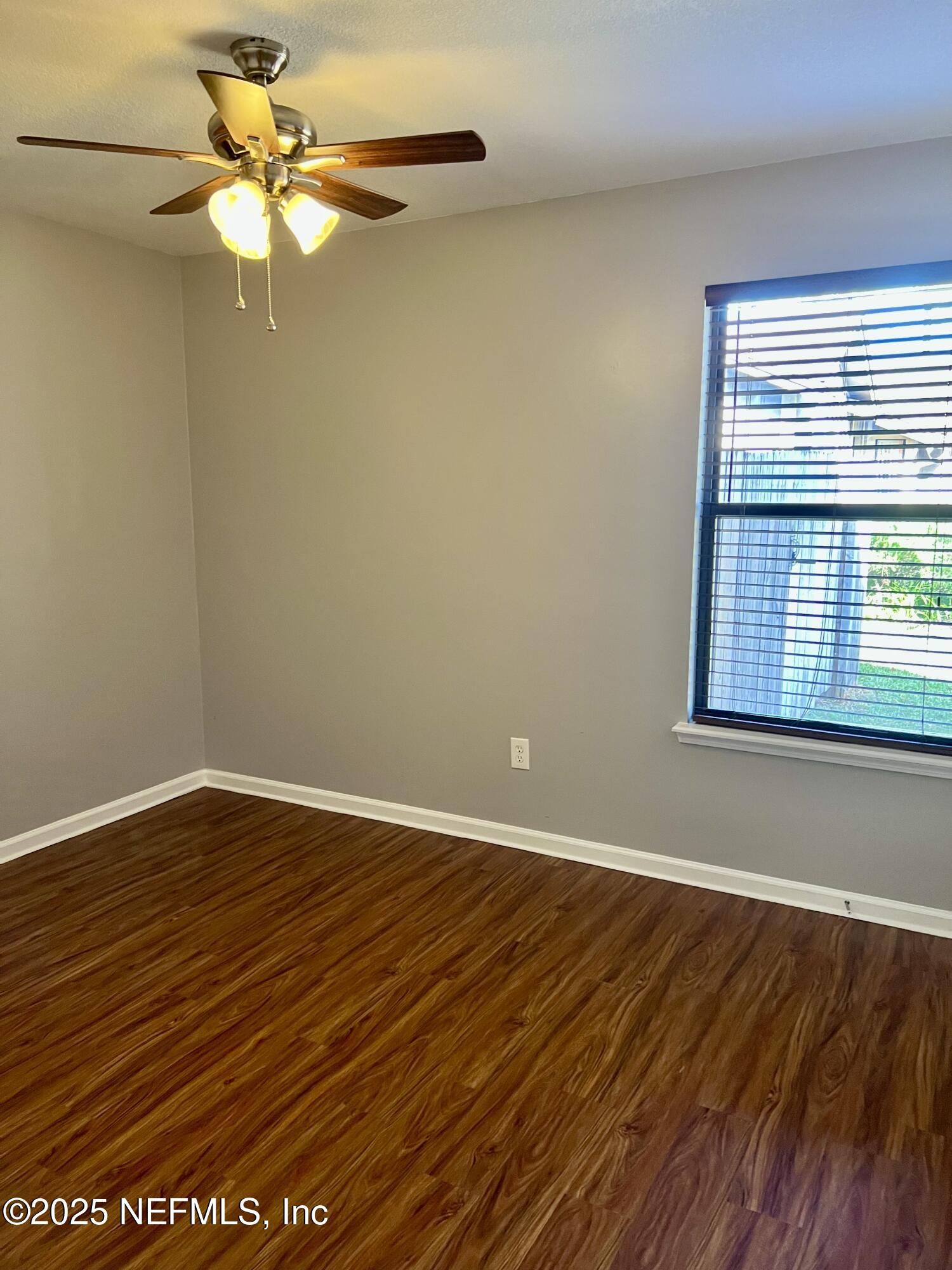 7820 Collins Ridge Boulevard East Jacksonville, FL 32244 - Photo 20 of 27 a view of an empty room with wooden floor and a window