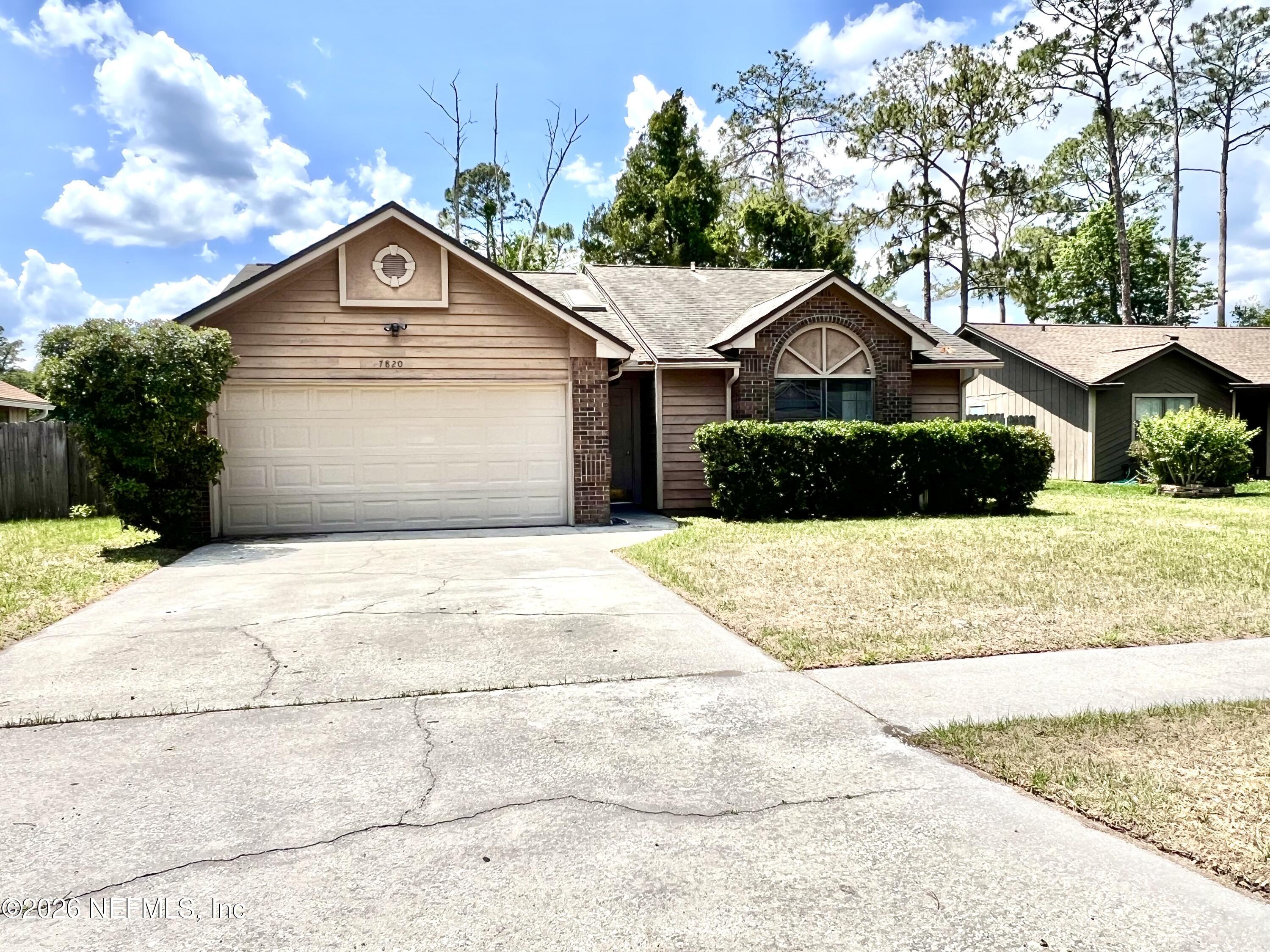 7820 Collins Ridge Boulevard East Jacksonville, FL 32244 - Photo 25 of 27 a front view of a house with a yard