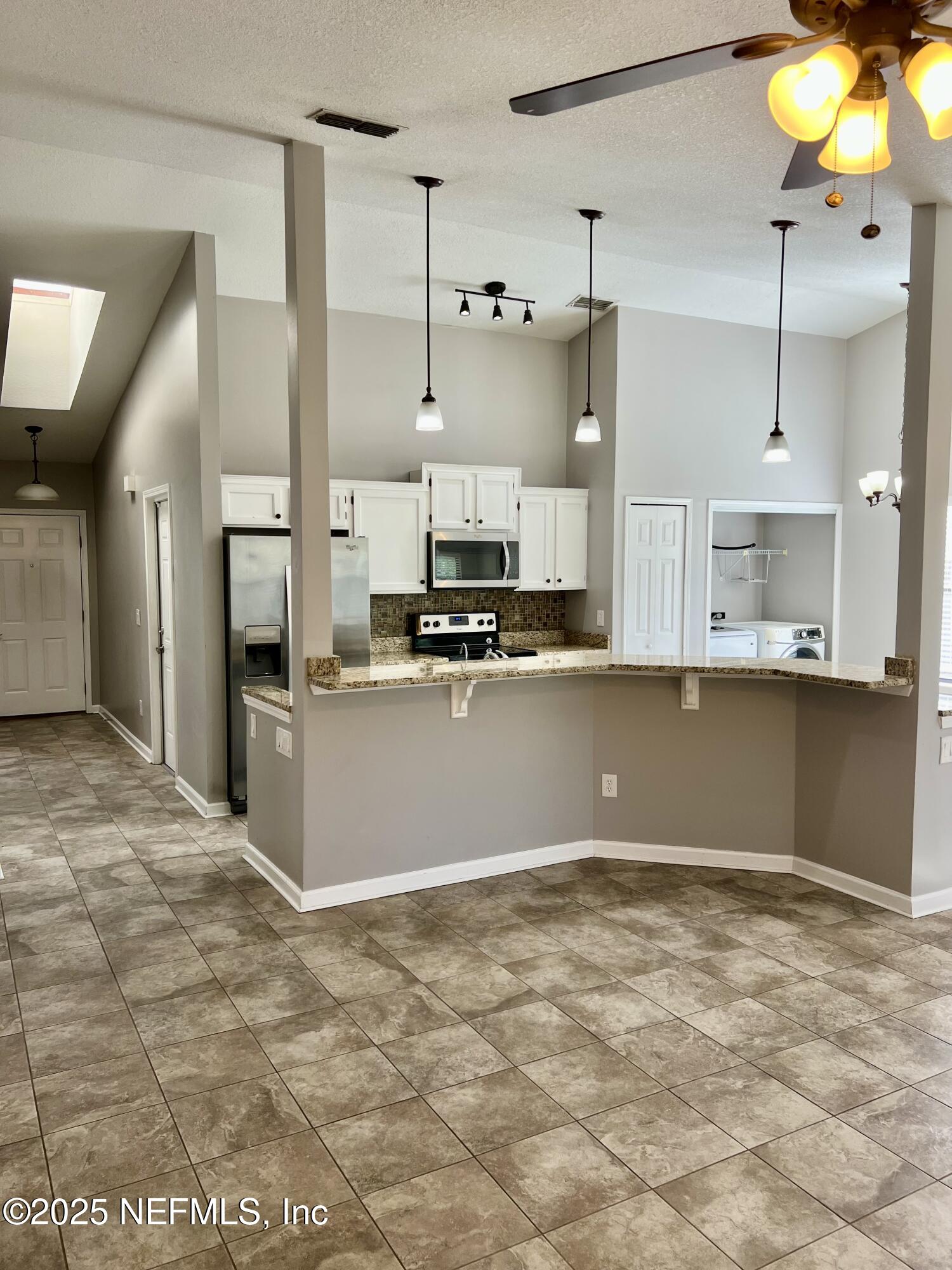 7820 Collins Ridge Boulevard East Jacksonville, FL 32244 - Photo 3 of 18 a view of kitchen with cabinets and window